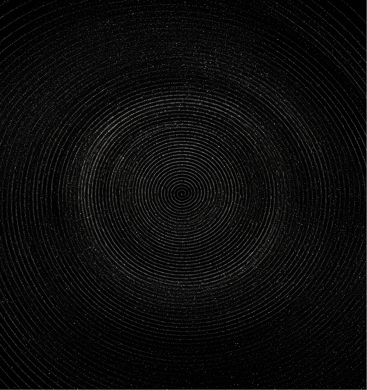 Concentric circular pattern on a black background creating a spiral effect with fine dotted details.