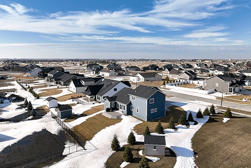 Housing development in North Dakota during winter with snow.