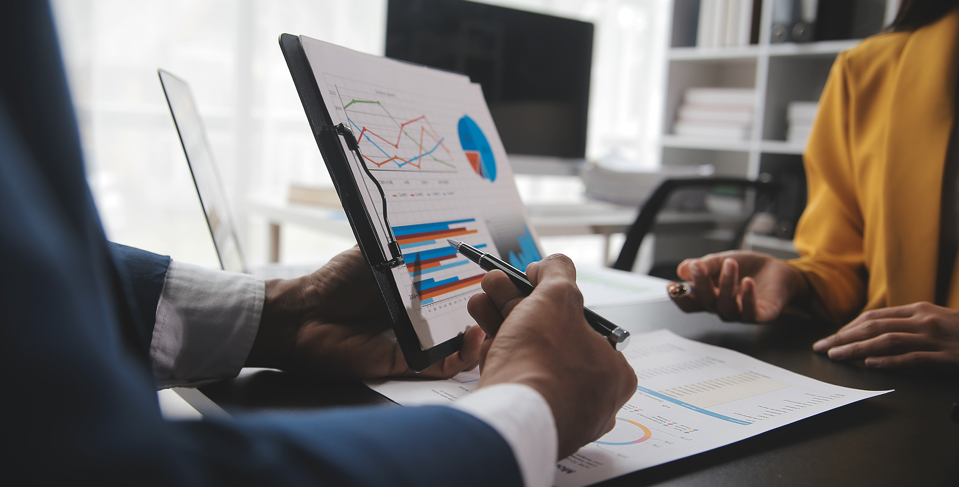 Two people looking at financial investments.