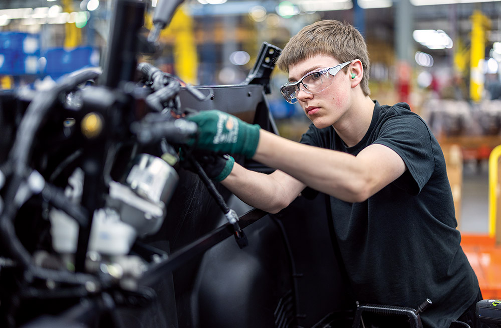 Young man working the line at a factory in Minnesota.