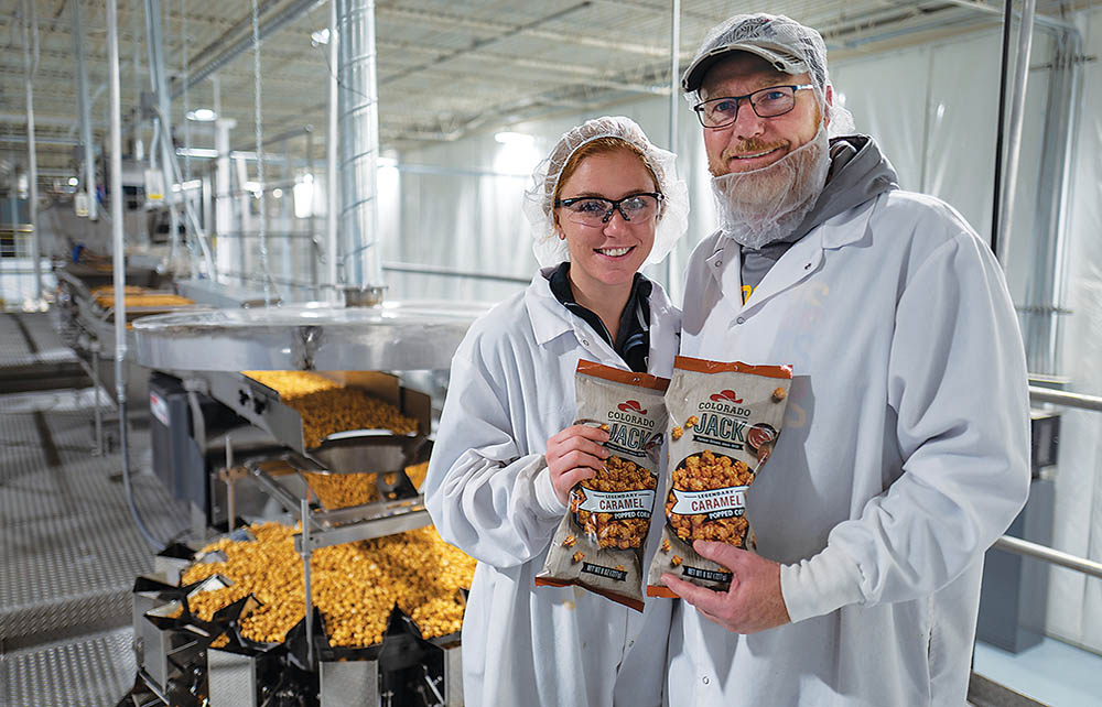 Employees of CoJack Popcorn standing in their facility.