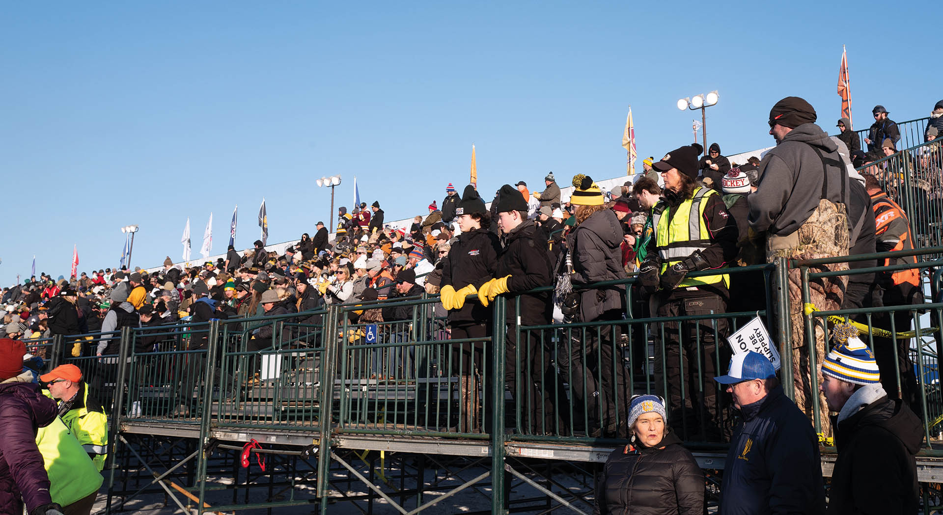 People gathered outside in winter to watch a local hockey game.