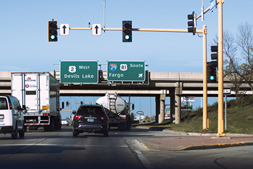 Street and stoplight with traffic in a North Dakota community.