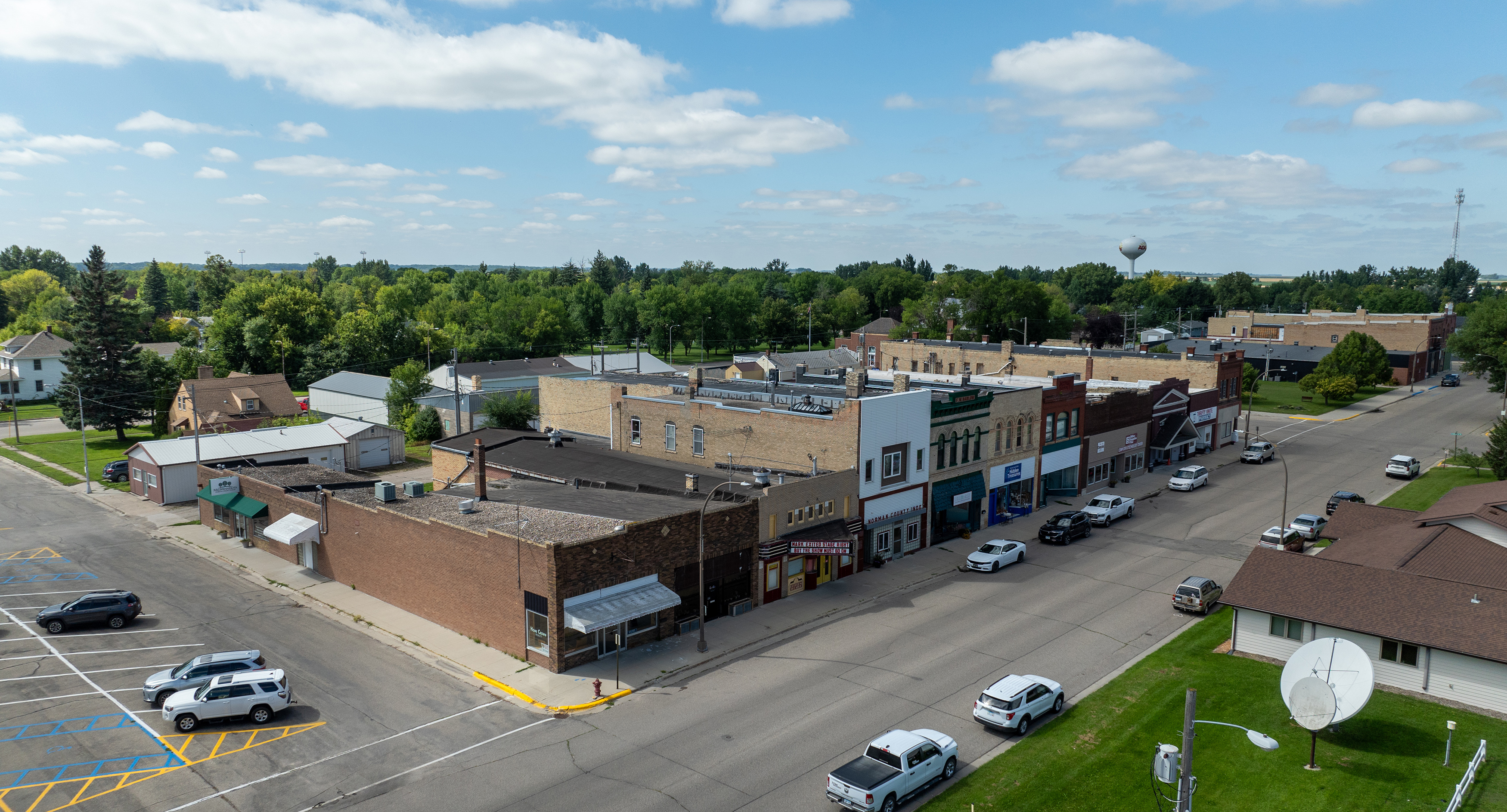 Aerial view of a neighborhood in Center, N.D. with green grass and blue skies
