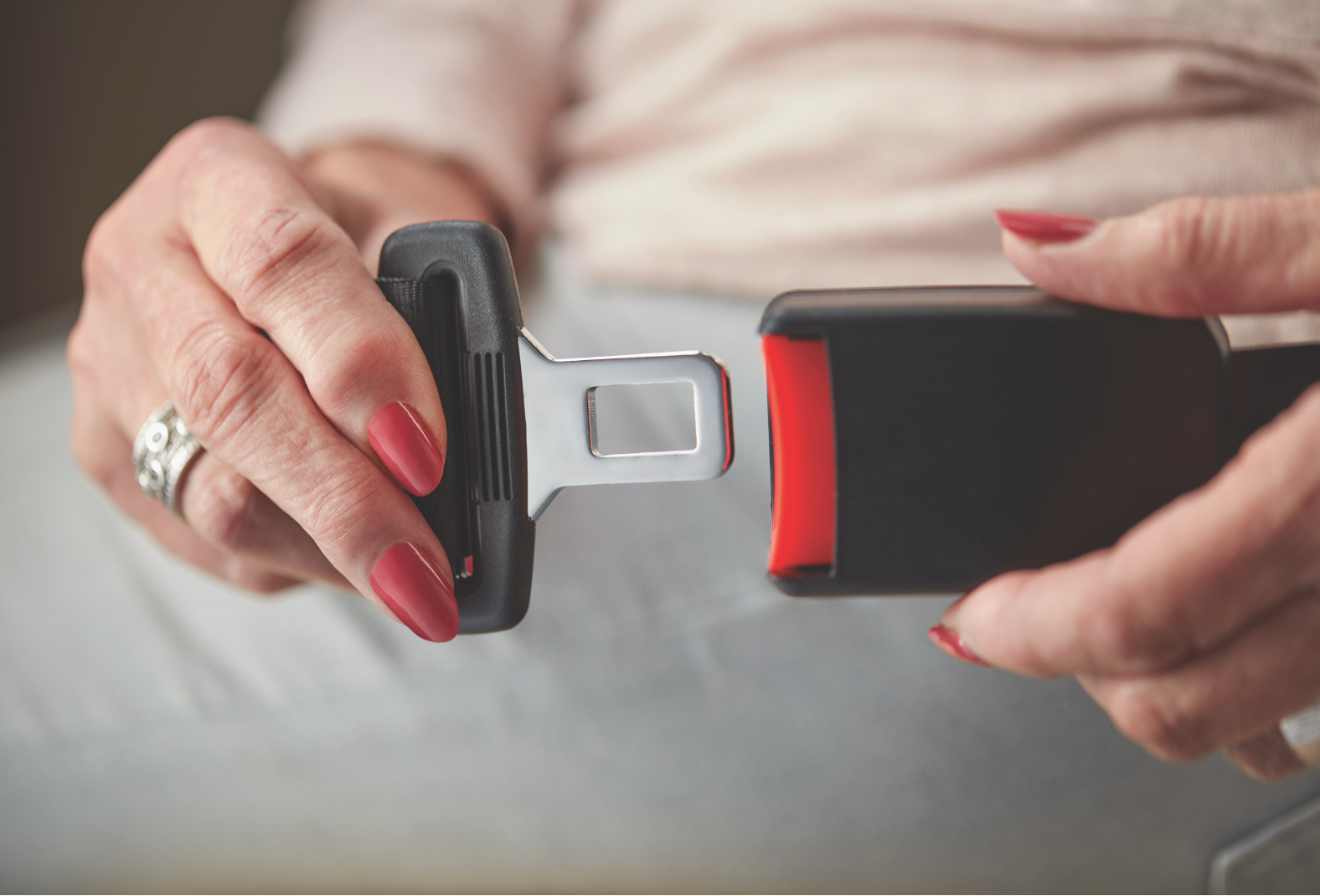 Close-up of a stairlift seatbelt being fastened, highlighting Homelife Stairlifts’ safety features for secure stair travel.