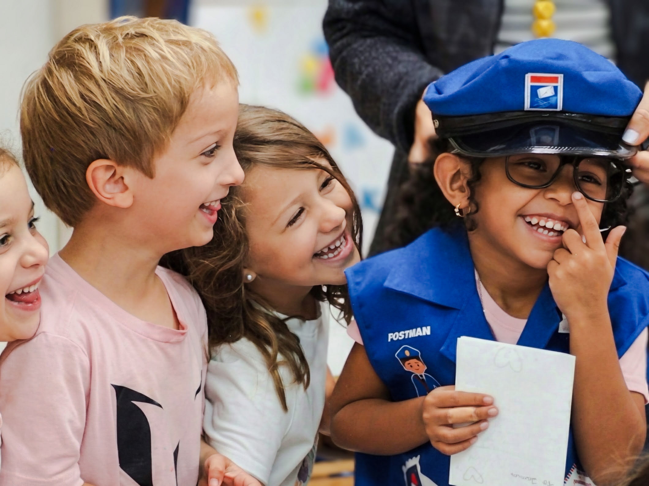 Gordon students laughing together, one dressed in a mail carrier costume