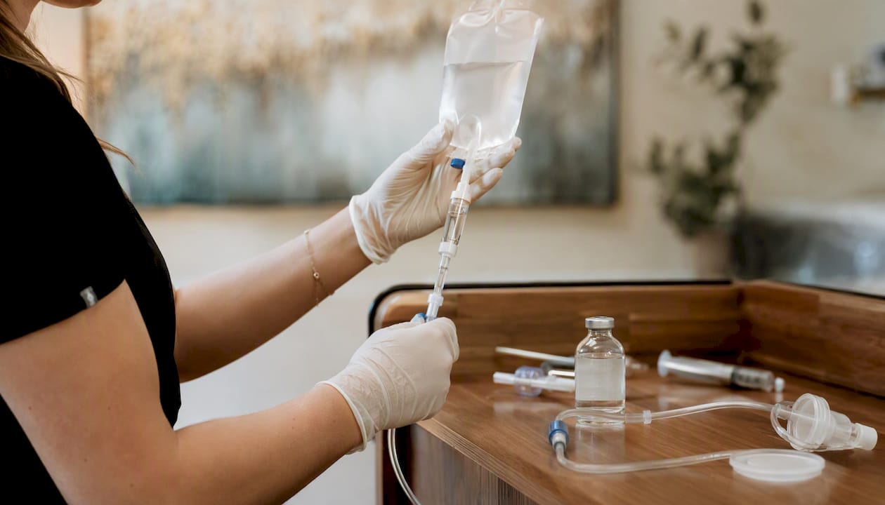 Hands preparing ketamine IV infusion