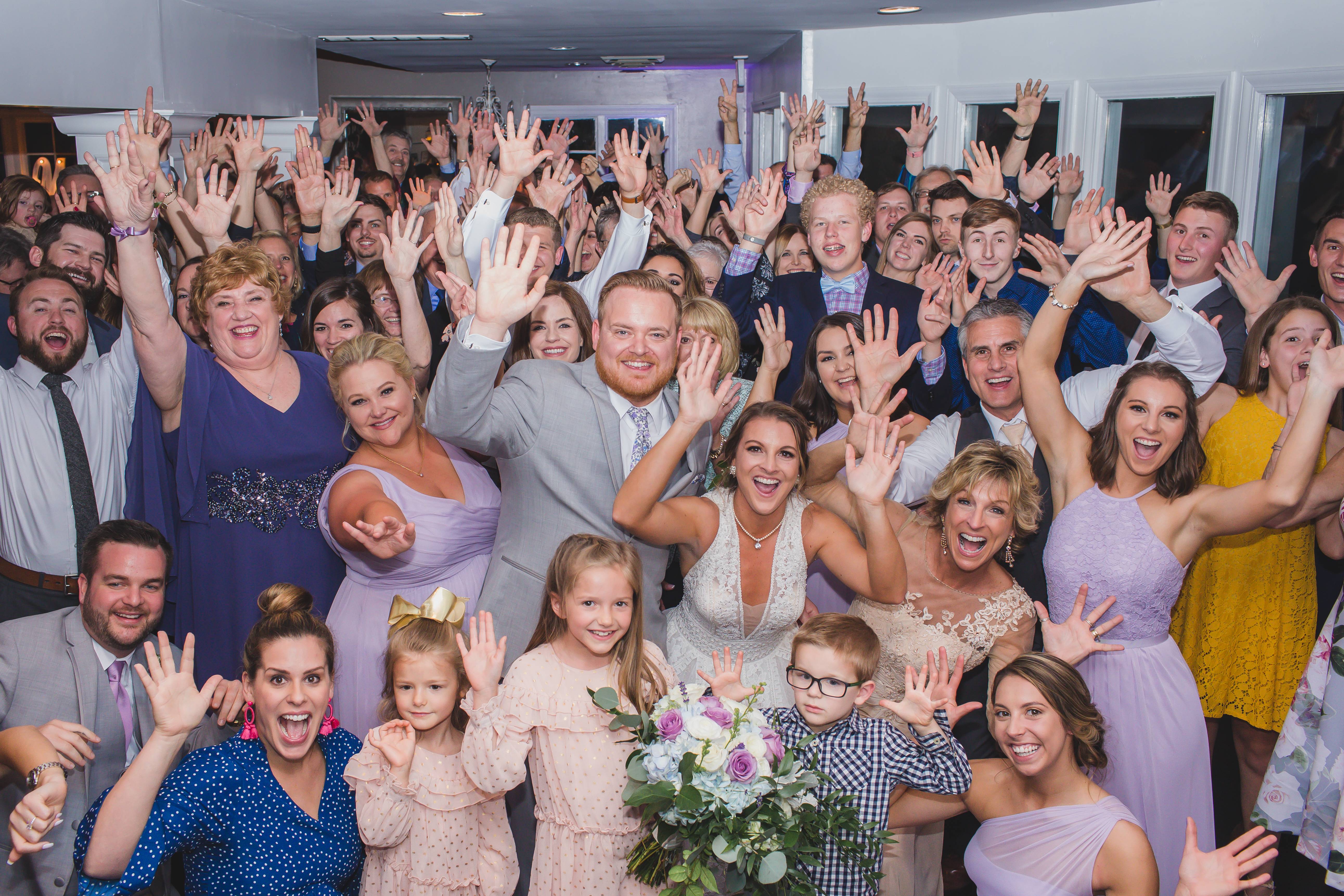wedding reception guests gather with the wedding party on the dance floor as they are surprised by a DJ Connection group photo