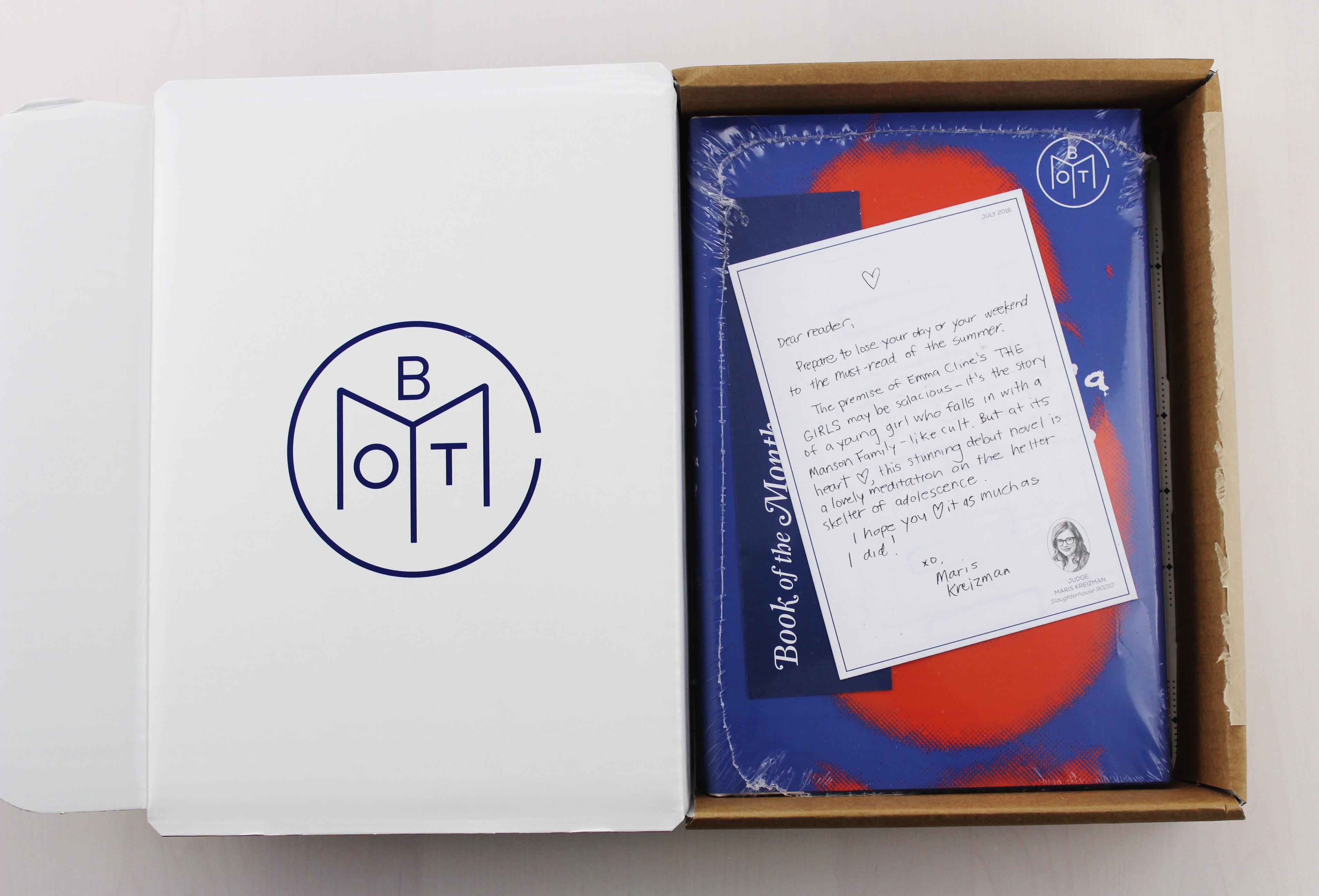 book in cellophane inside of a white box with a hand written letter atop the book