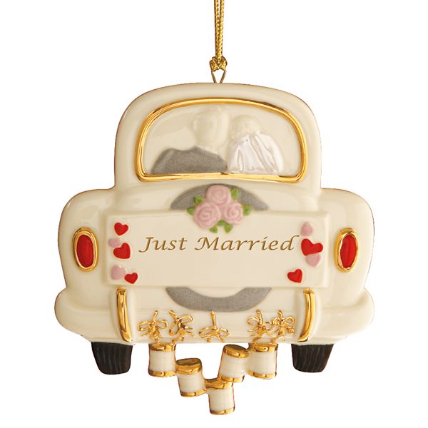 glass ornament resembling the classic frame of the rear of a car reading just married with cans dragging behind the car
