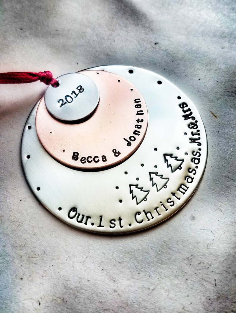 layered round metalic circles bound by a red ribbon reading 2018 becca and jonathan our 1st christmas as mr and mrs