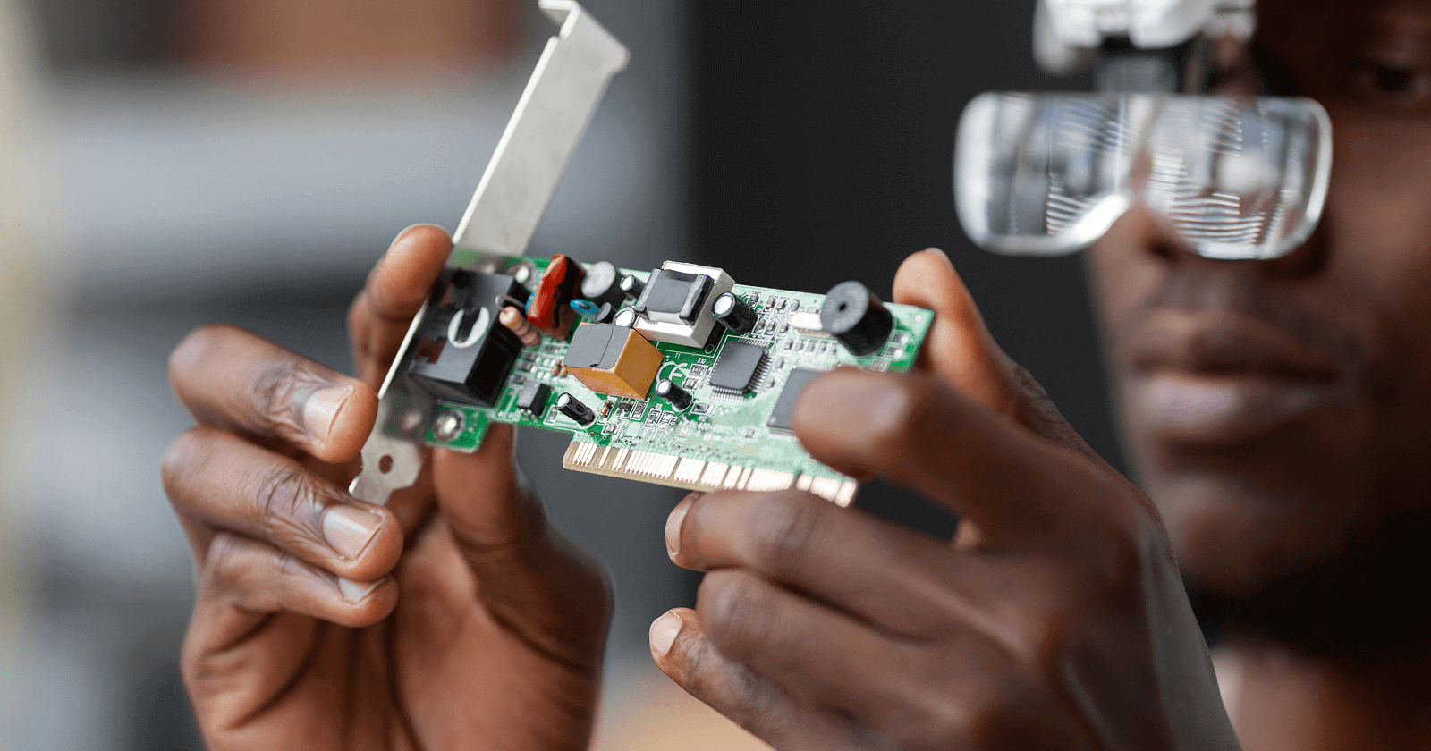 A person is working with a electronic chip.