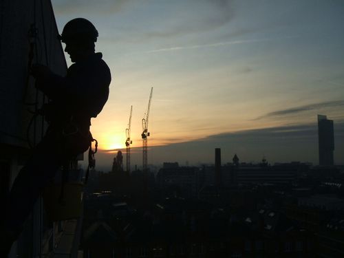 Rope Access Technician performing an inspection above Manchester Skyline