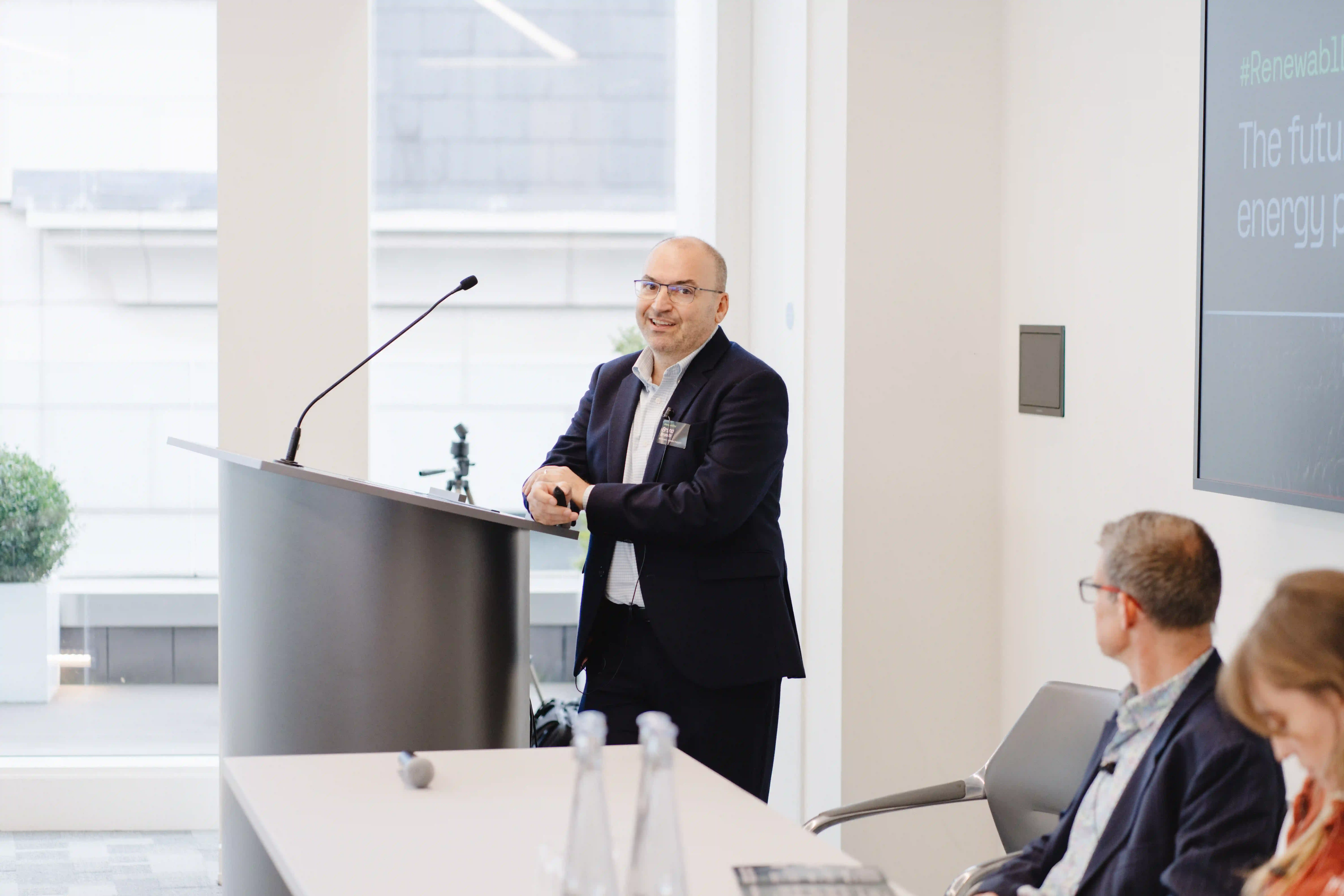 Bruno Brunetti of S&P Global speaking from a lectern at Renewabl Day 2024 in London.