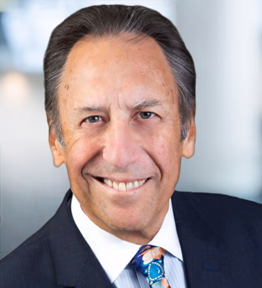 smiling man in suit and tie with a blue tie