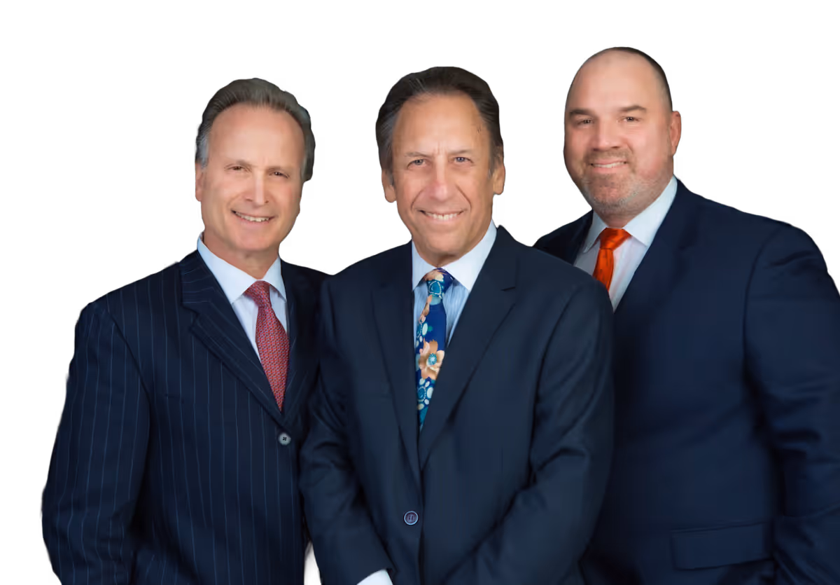Three men in formal business suits standing close together against a black background, all smiling.