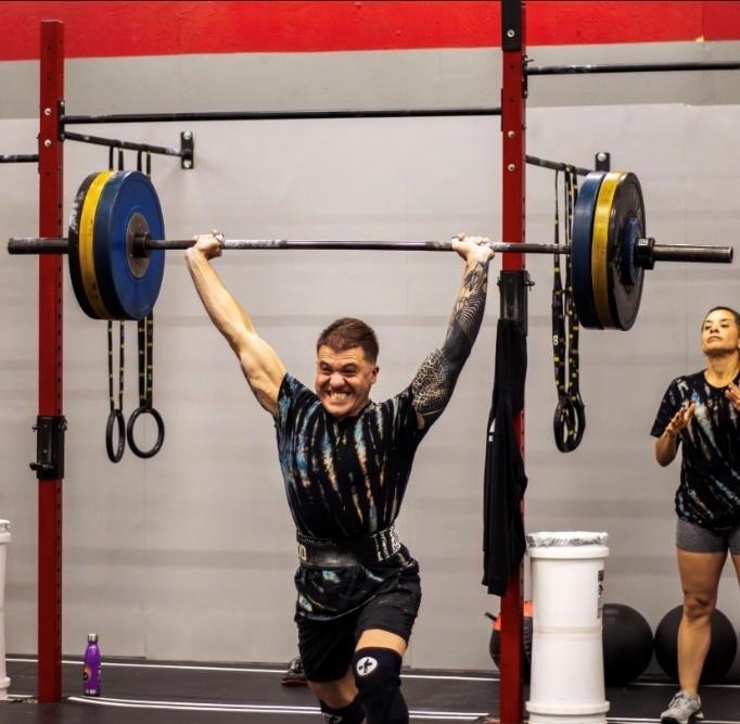 A person lifting weights in a gymAI-generated content may be incorrect.