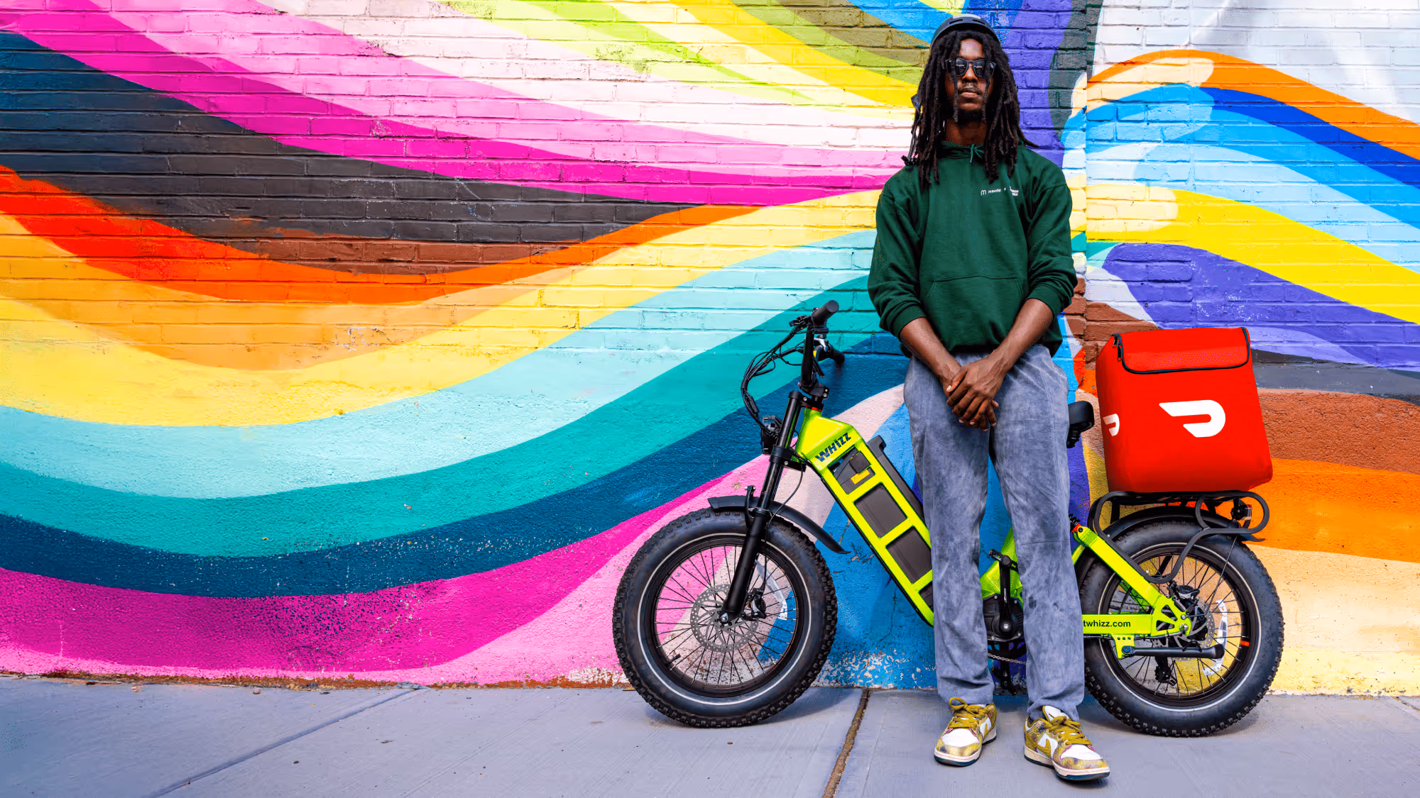 delivery rider standing near ebike 