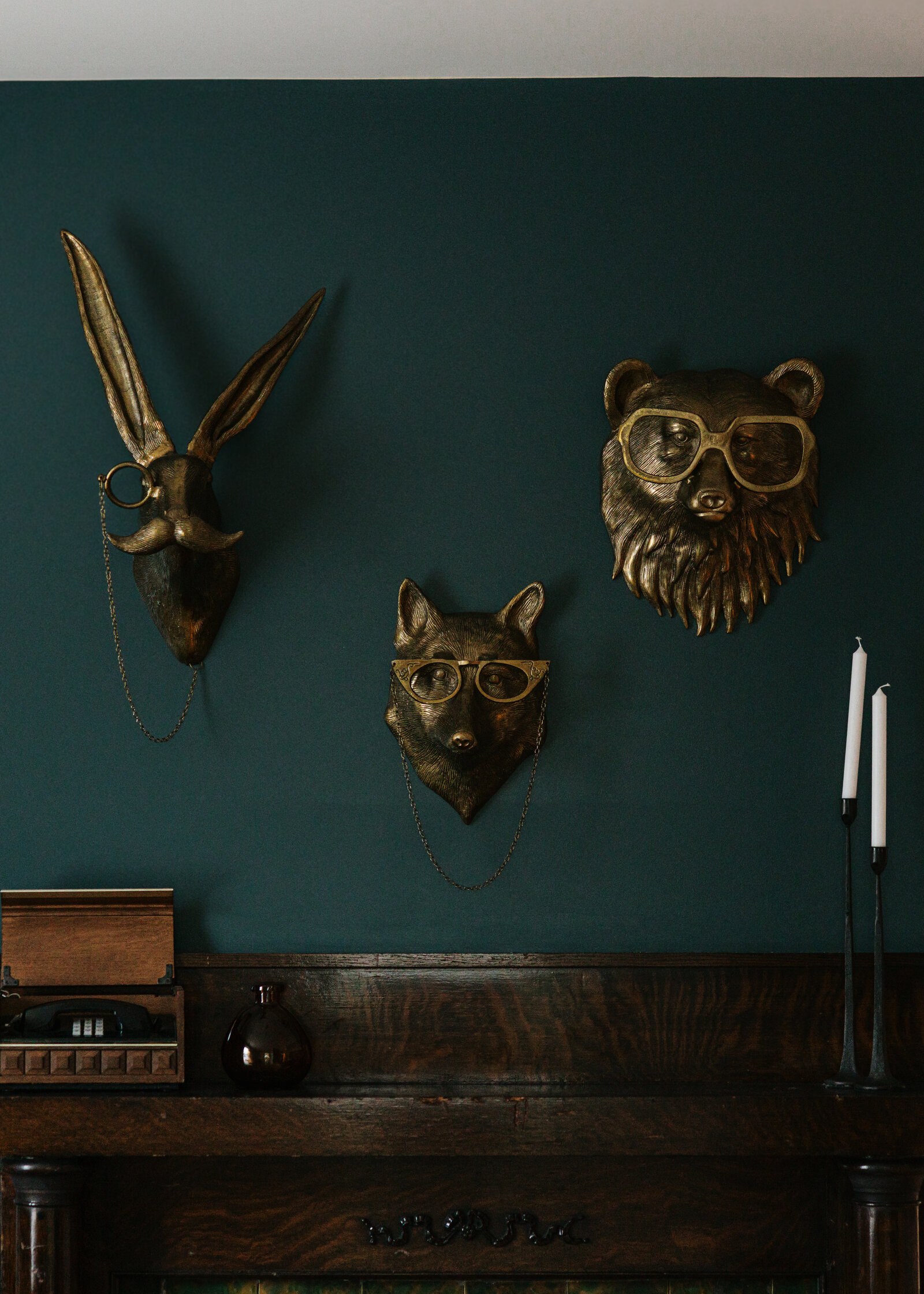 Redecorated mantle detail at The Grand Lux Inn with brass animal wall art