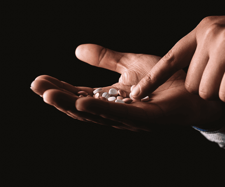 Man counting the pills in his hand