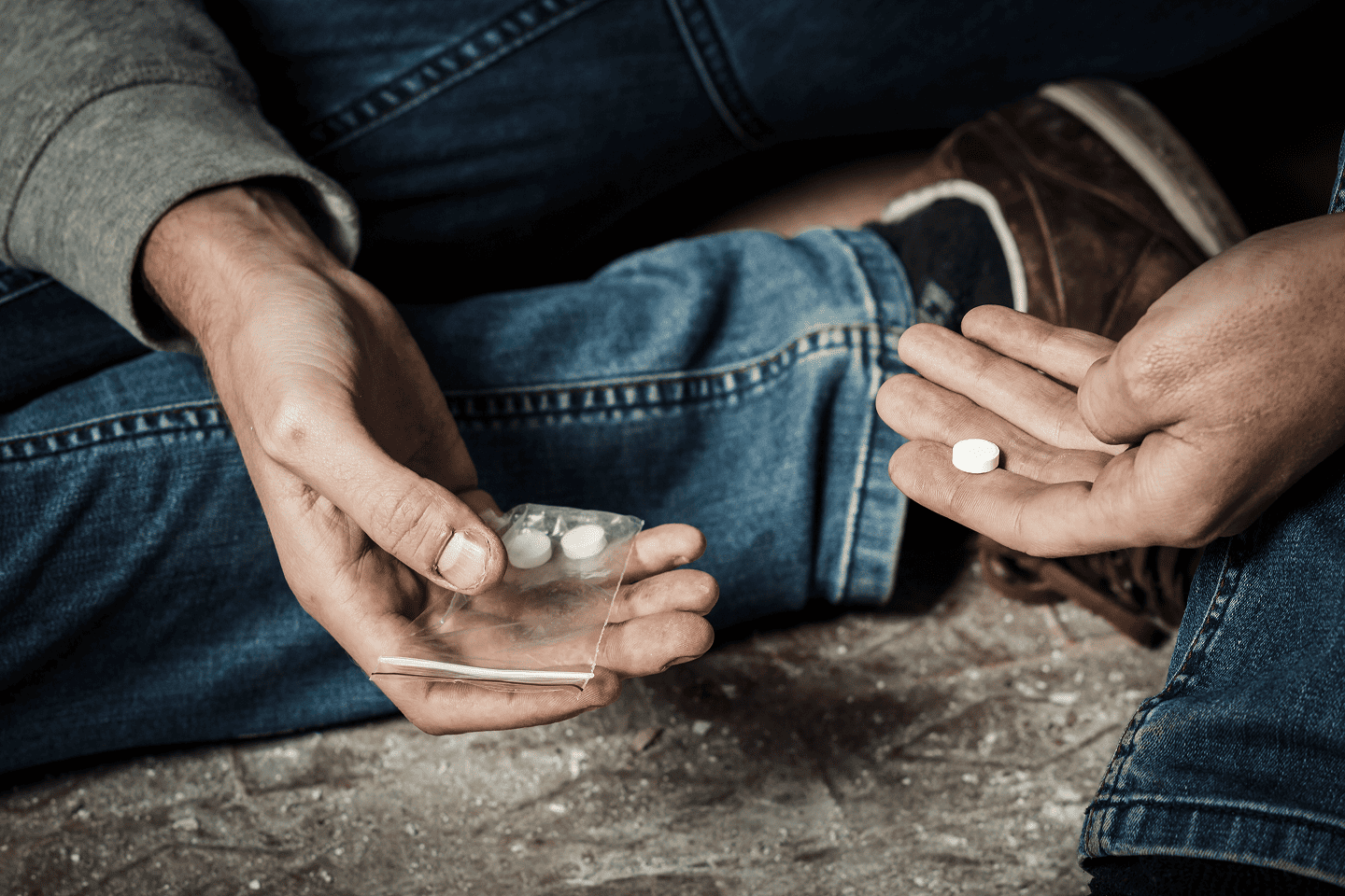 Man holding pills in his hand