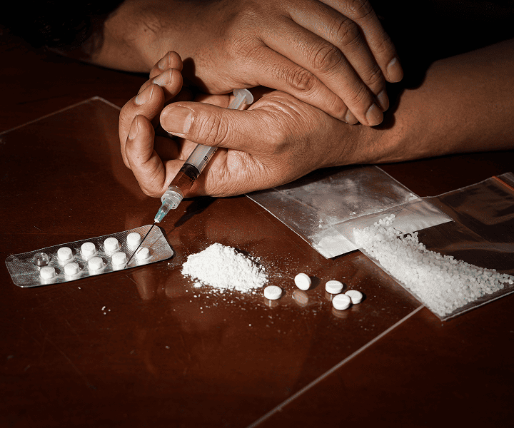 Man taking pills from the table