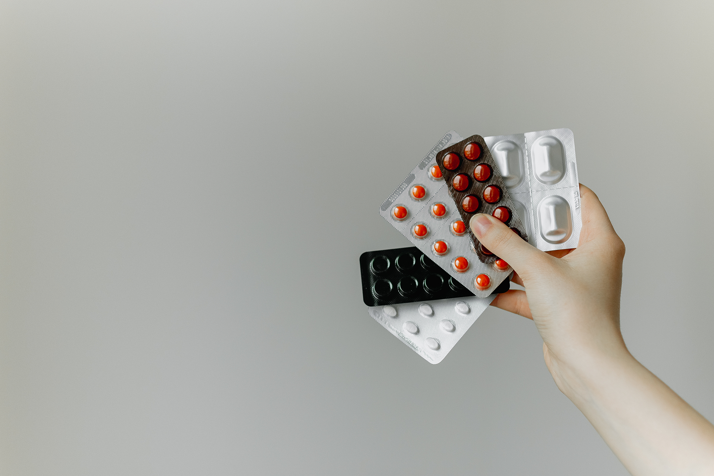 Woman holding different pills