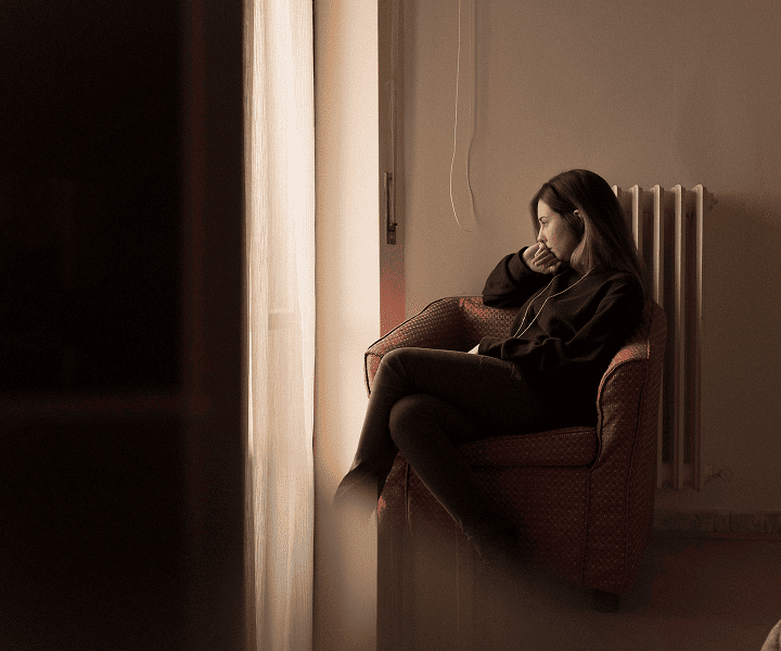 Desperate woman sitting in the corner