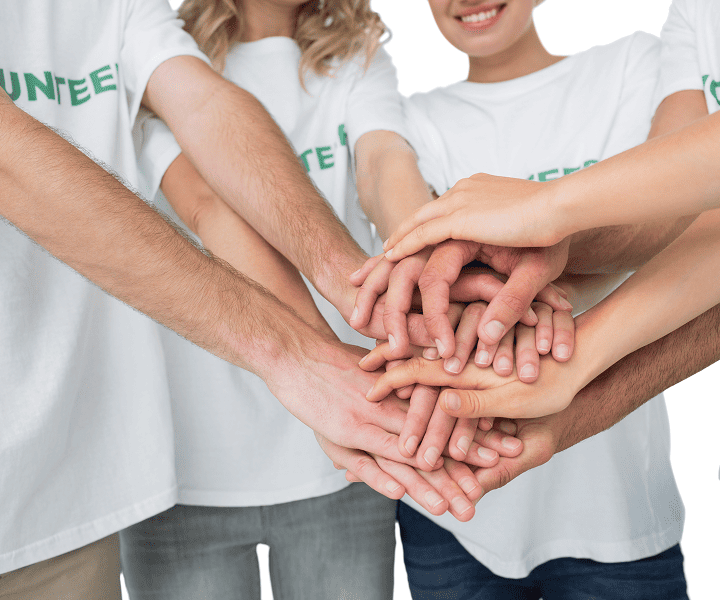 A group of people holding their hands together