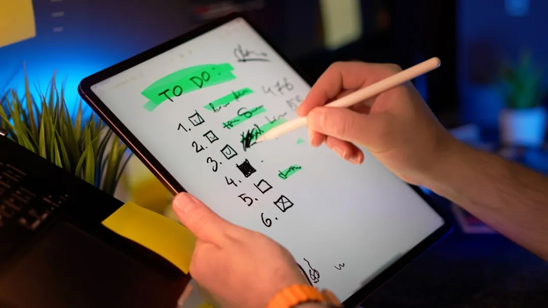 person reviewing checklist on tablet - Mobile App Development Agency Chicago: The Complete Buyer's Guide