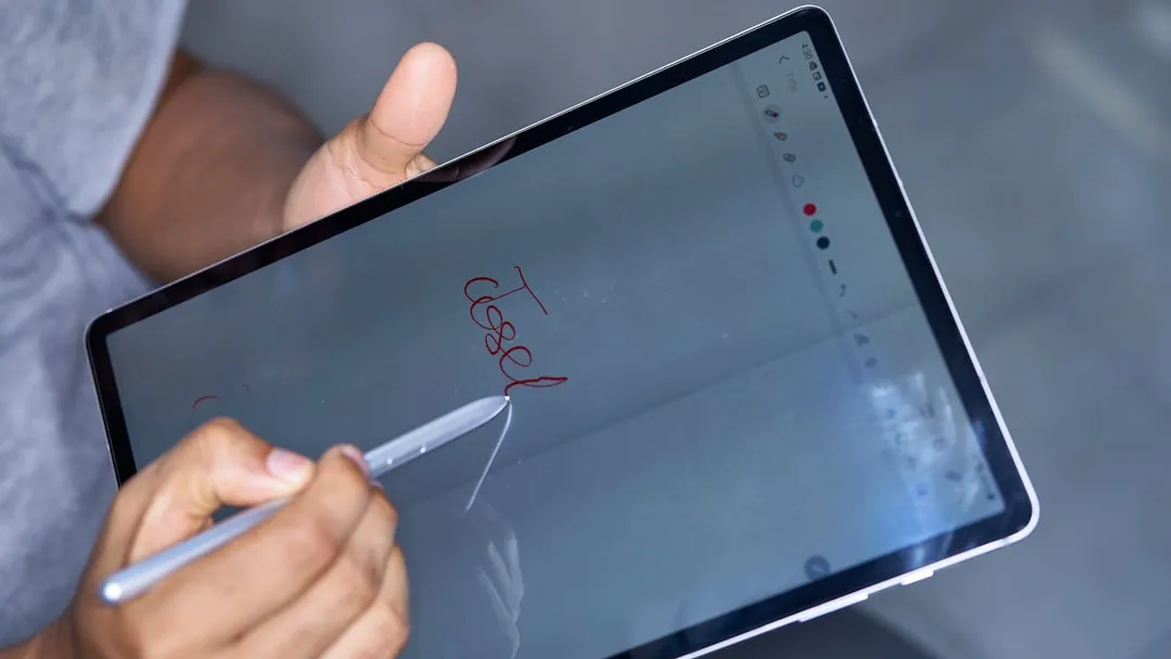 business professional building an app on a tablet - Why No-Code Alone Isn’t Enough for Enterprise Applications business professional building an app on a tablet - Why No-Code Alone Isn’t Enough for Enterprise Applications