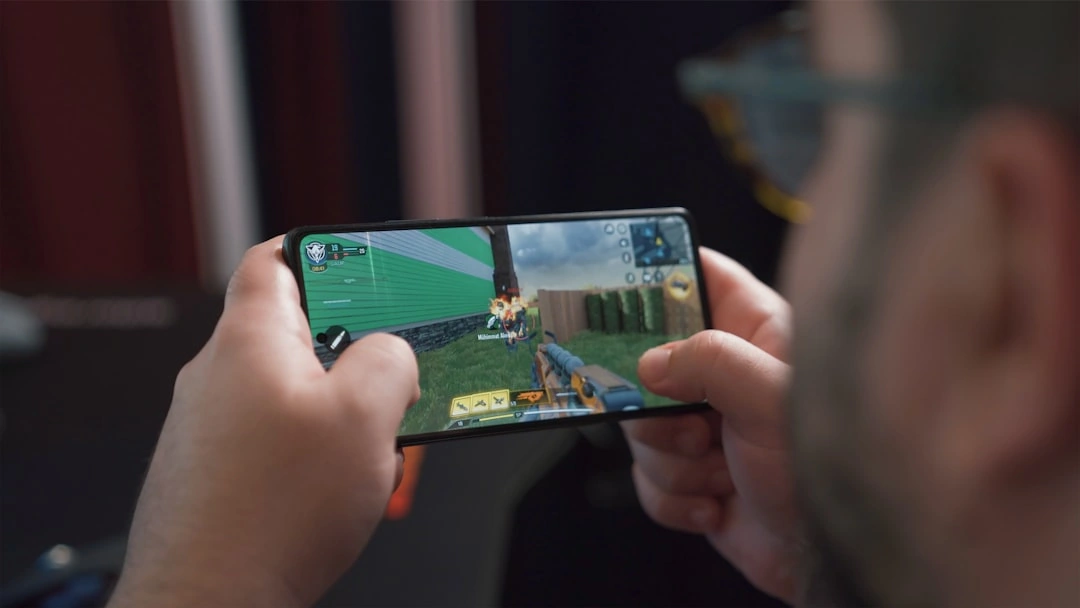 person playing mobile game on android phone - best google play paid games person playing mobile game on android phone - best google play paid games