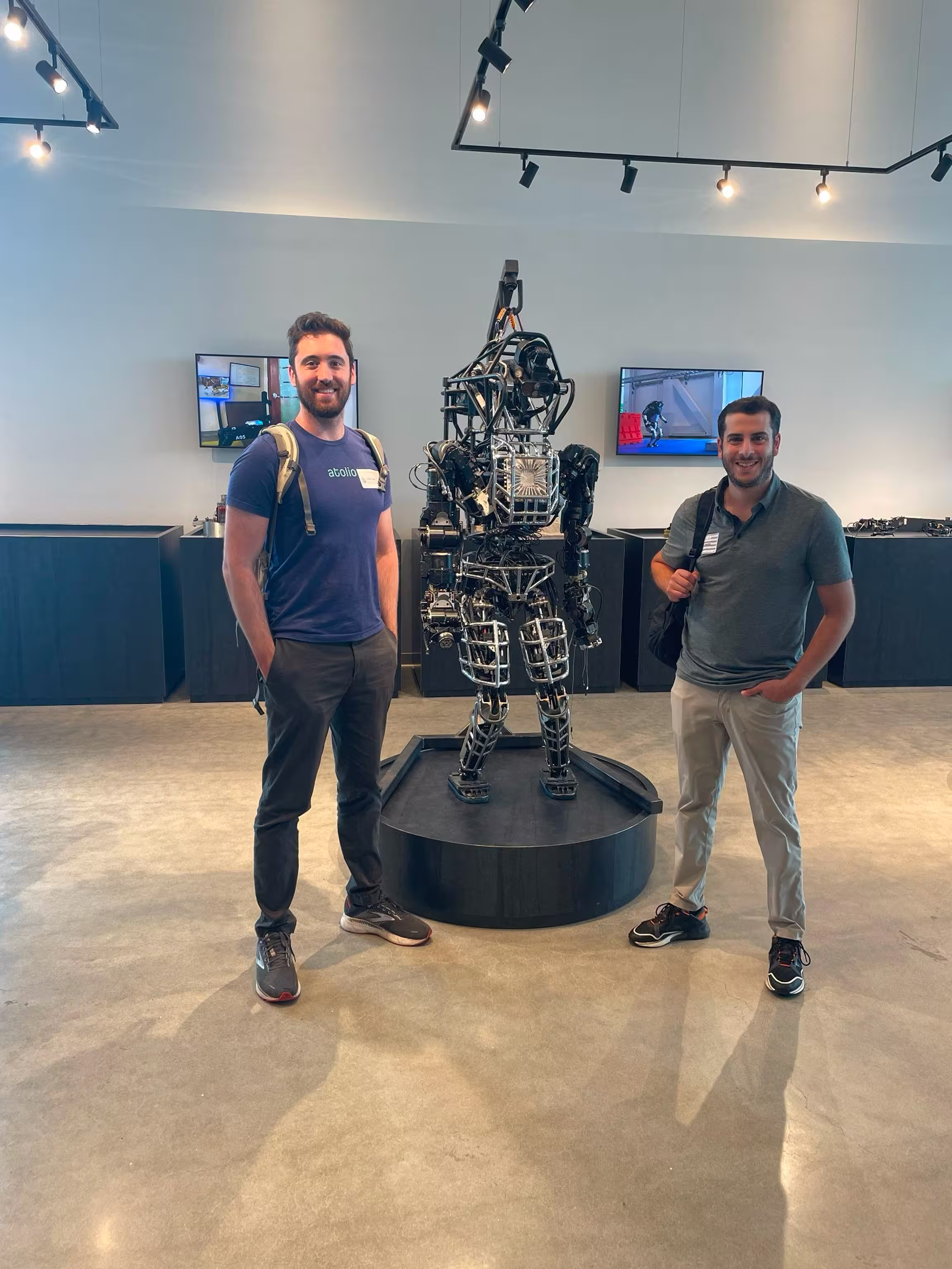 Atolio team members standing next to robot