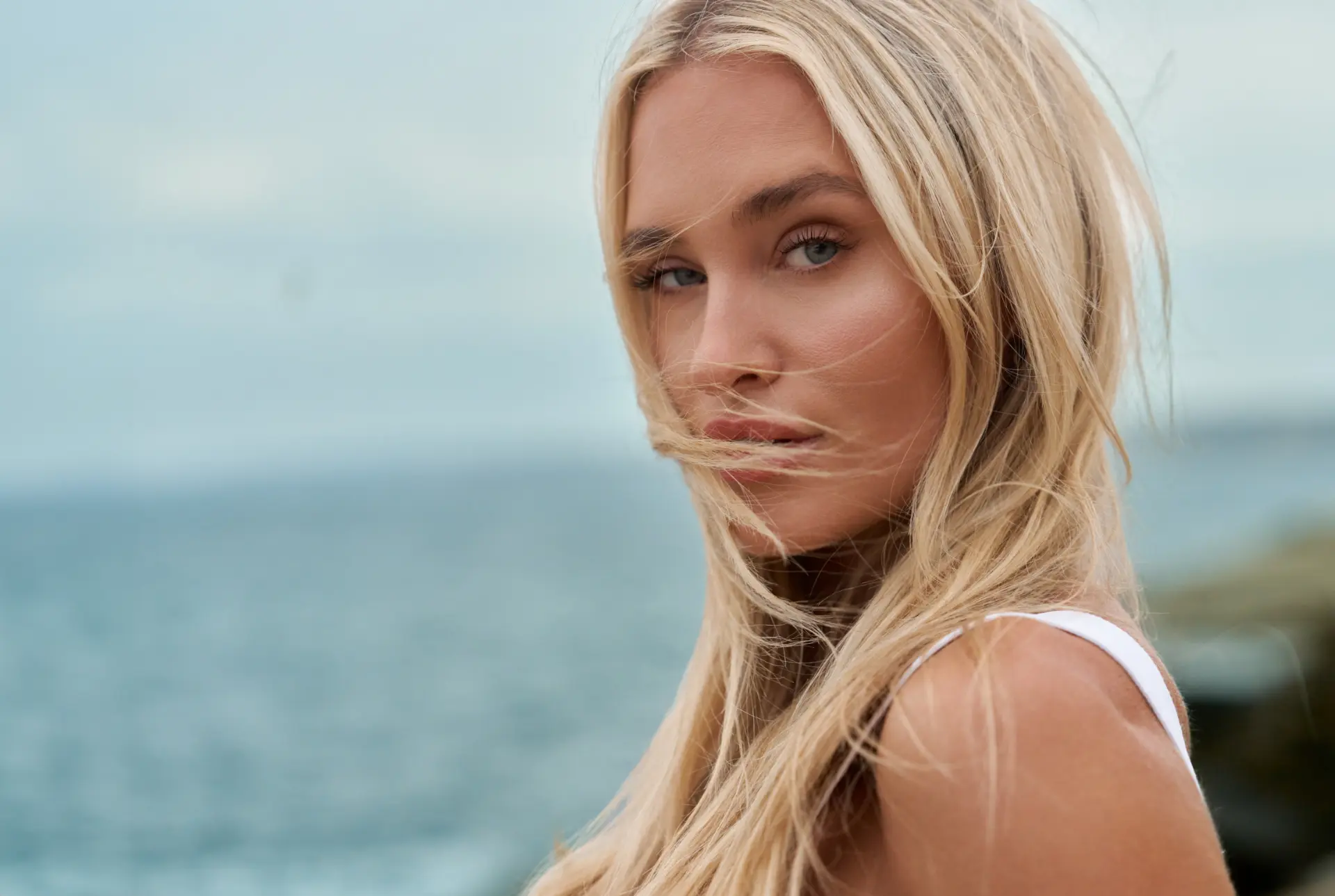 A young woman's face that is free of any deep expression lines