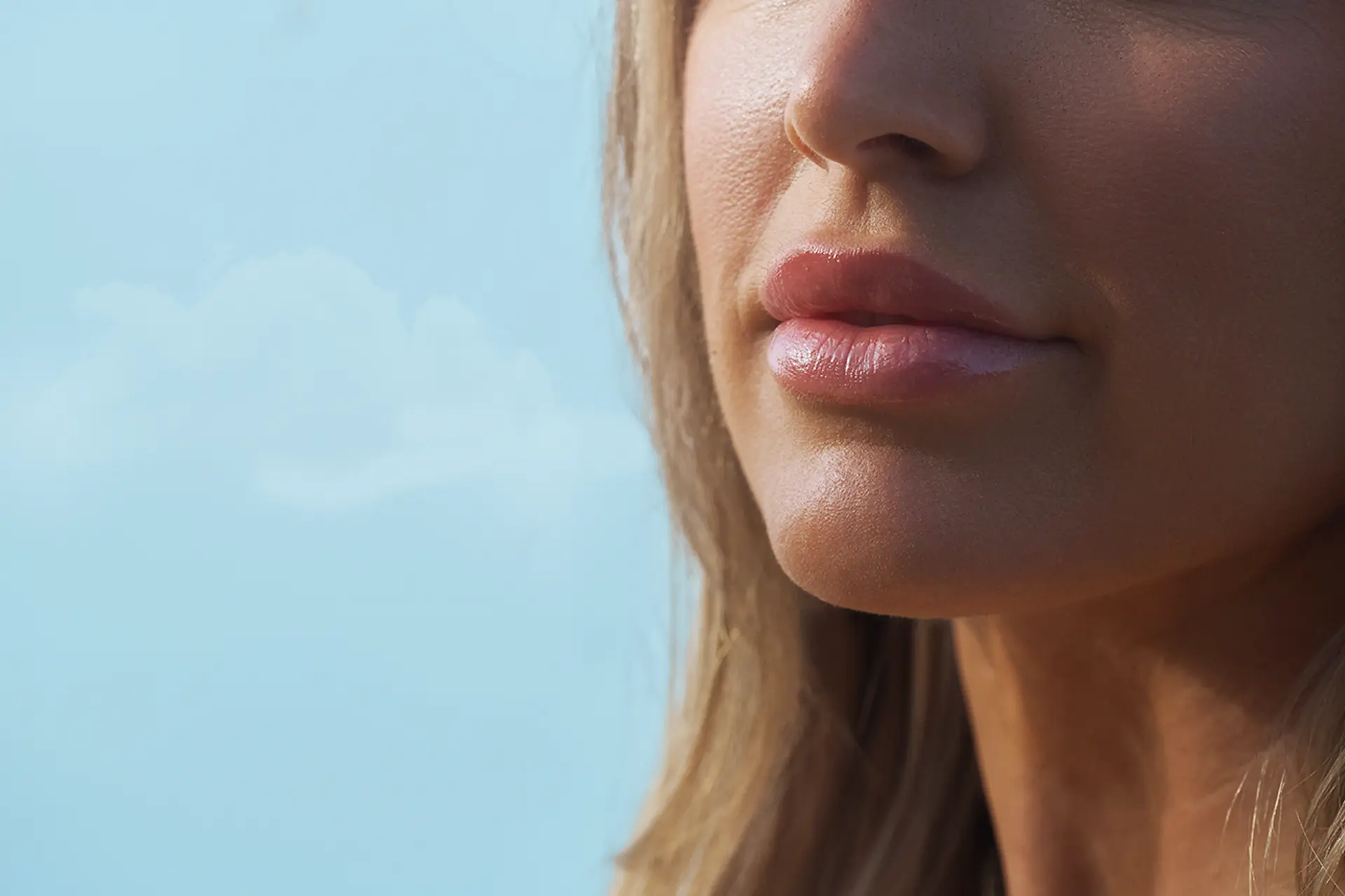 A close-up of a woman's face with symmetrical, voluminous lips