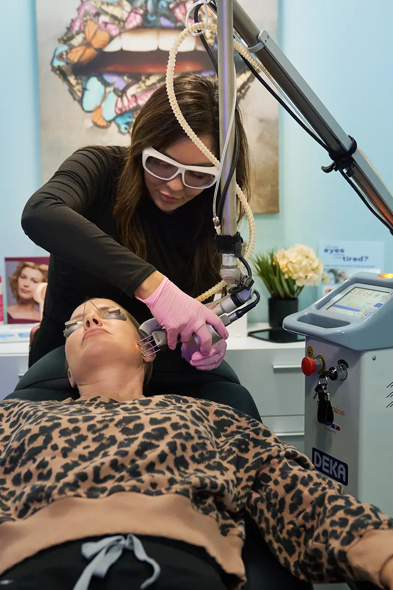 Katie Martin, PA-C performing Deka DOT® laser treatment on a woman's lower jawline in Fallbrook, CA