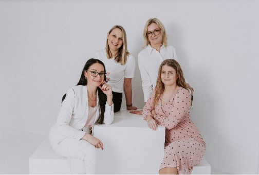 A group of women posing for a photoAI-generated content may be incorrect.