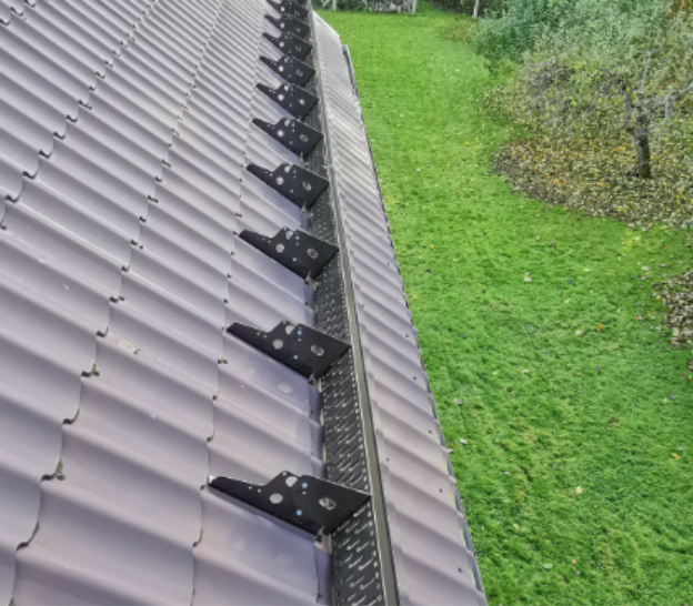 A roof of a building with a lawn and treesAI-generated content may be incorrect.