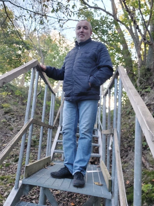 A person standing on a metal staircaseAI-generated content may be incorrect.
