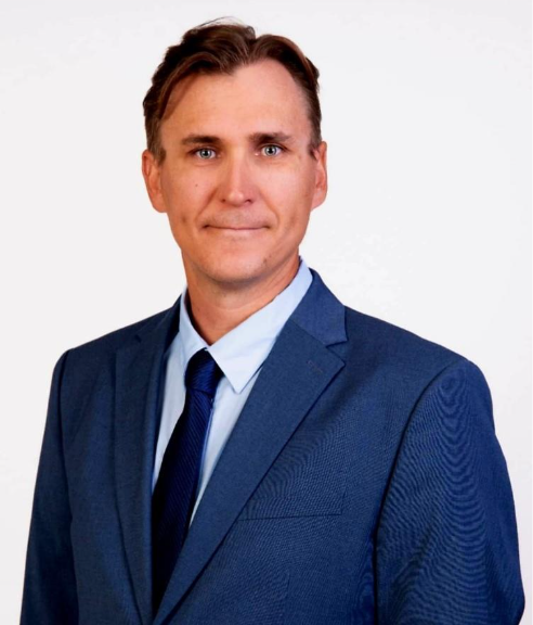 A person in a suit and tieAI-generated content may be incorrect.