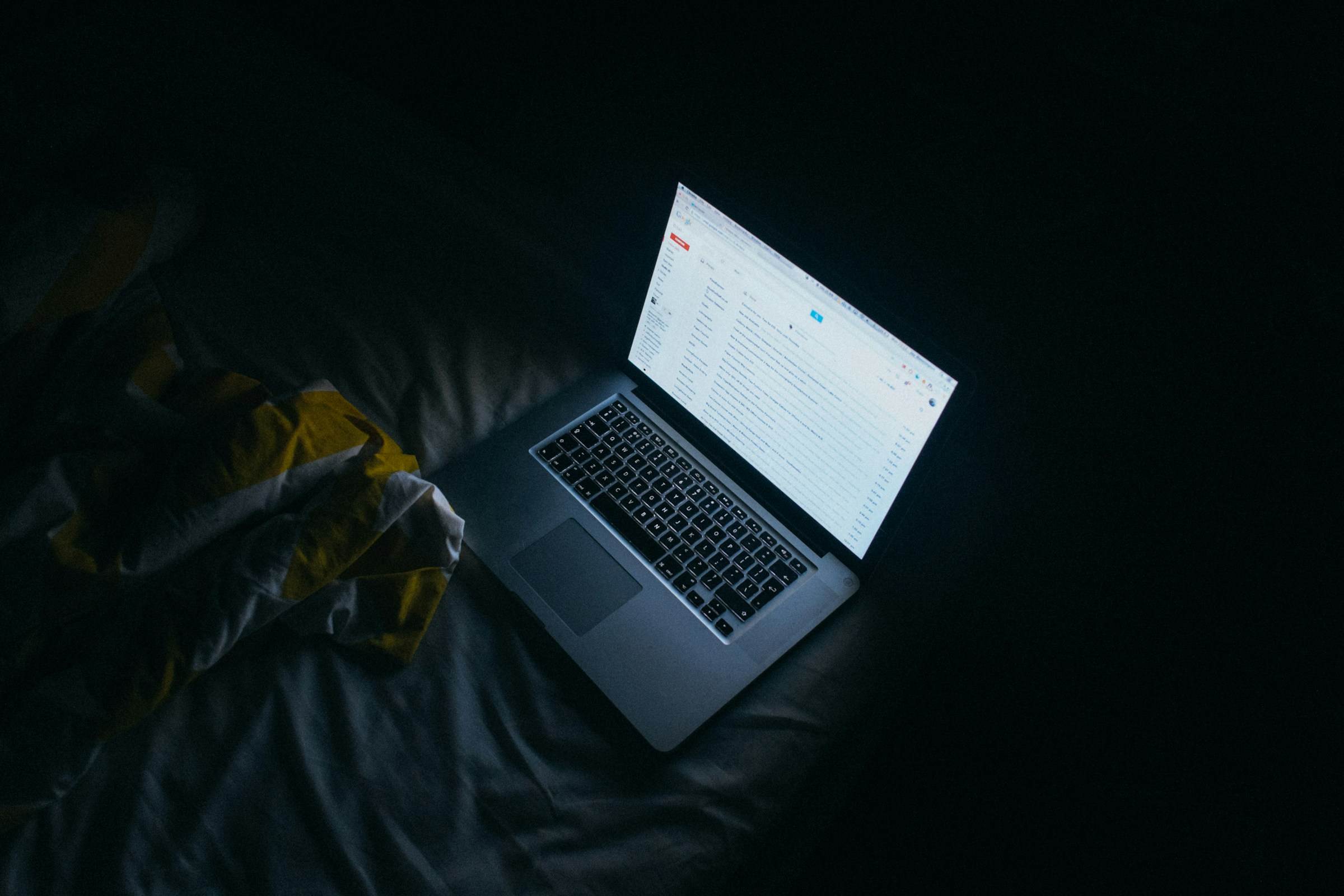 laptop on a bed - How to Clean up Emails in Gmail