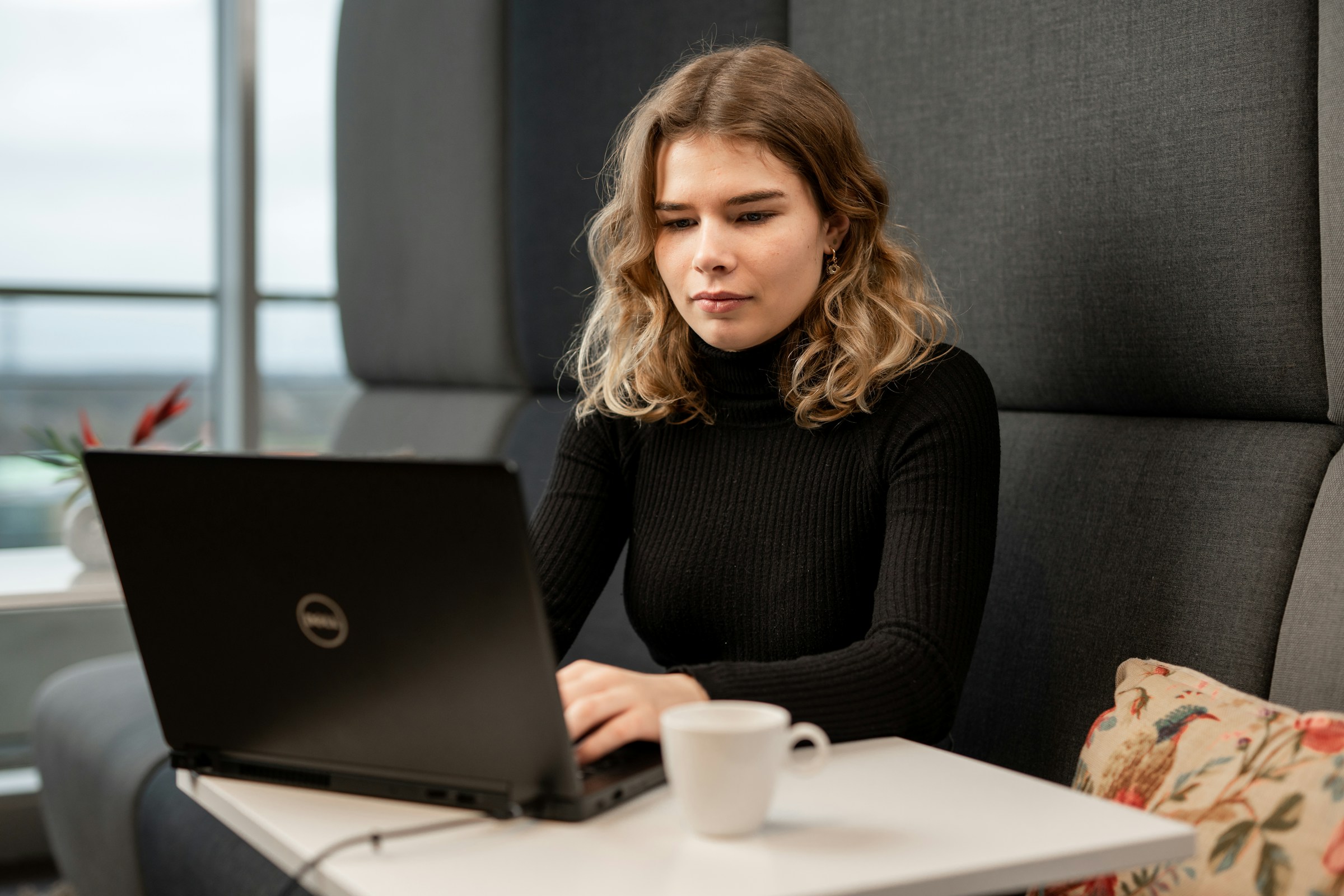 woman using a laptop -  How to Delete Large Amounts of Emails in Gmail 