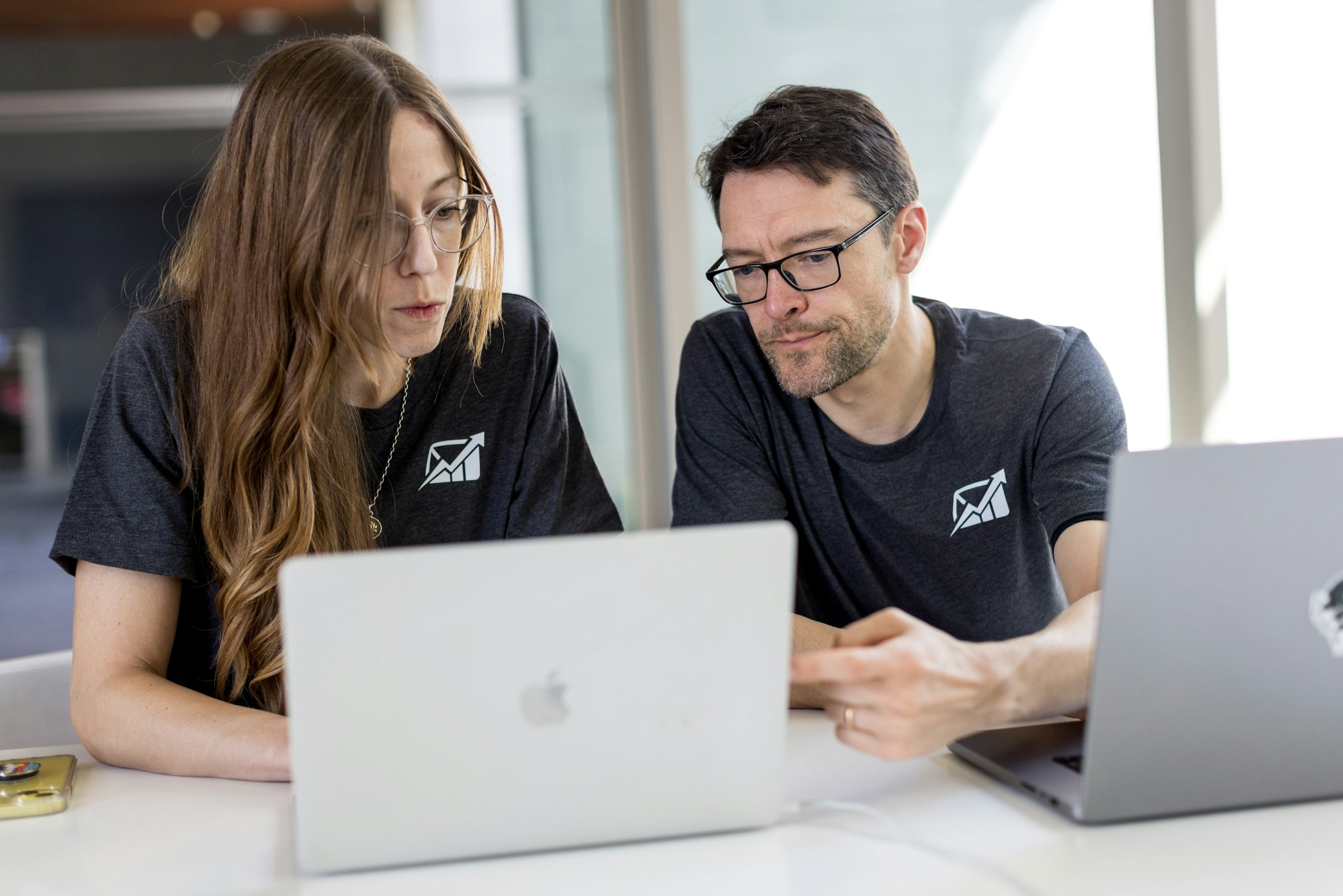 employees working on a laptop - How to Clean Up Email 