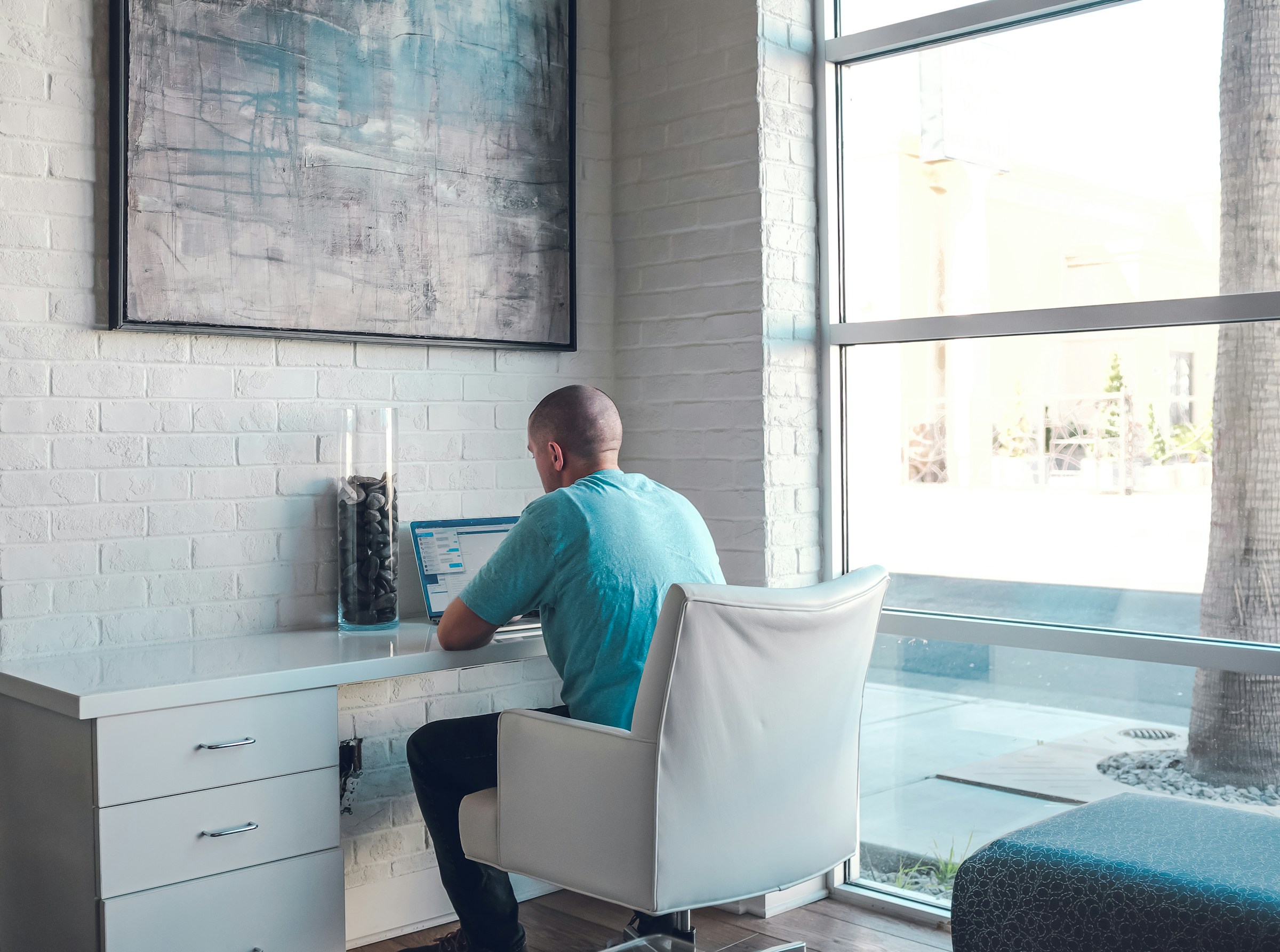 man working on a laptop - Mailstrom vs. Clean Email