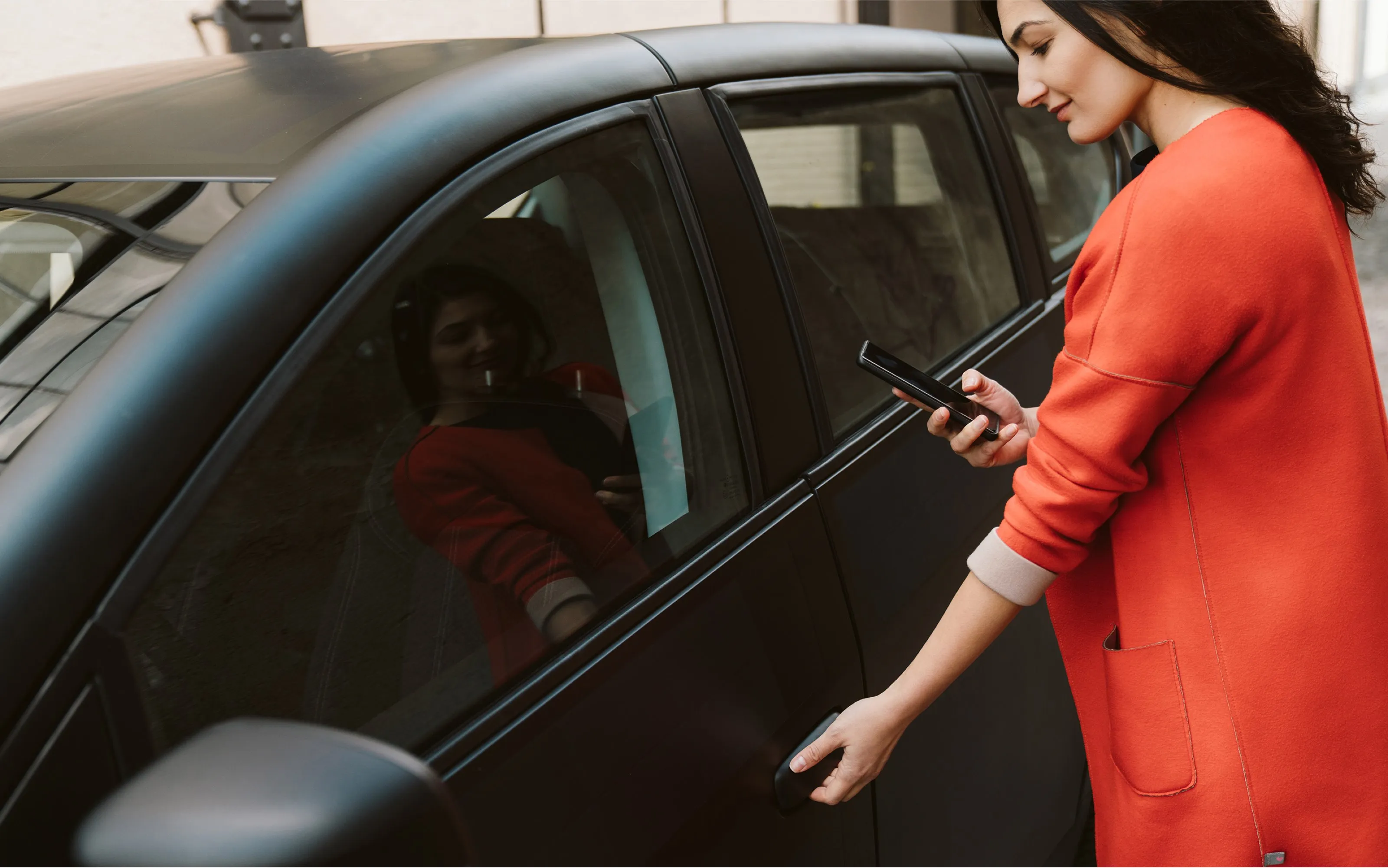 a person using a phone in a car
