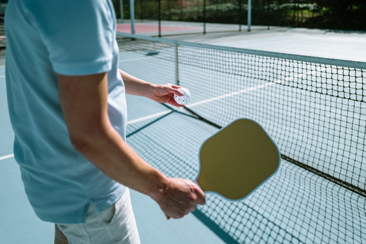 Person playing pickleball after PRP treatment for sports injury