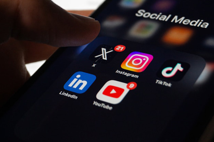 A person holding a phone about to click on a social media app.