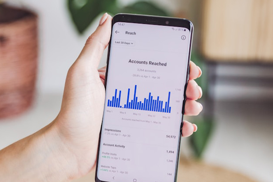 A person holding their phone viewing ad stats.