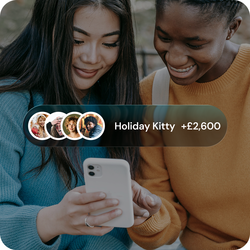 Two friends topping up their shared bank account through the KittyCard app, adding to a Holiday Kitty ahead of a group trip