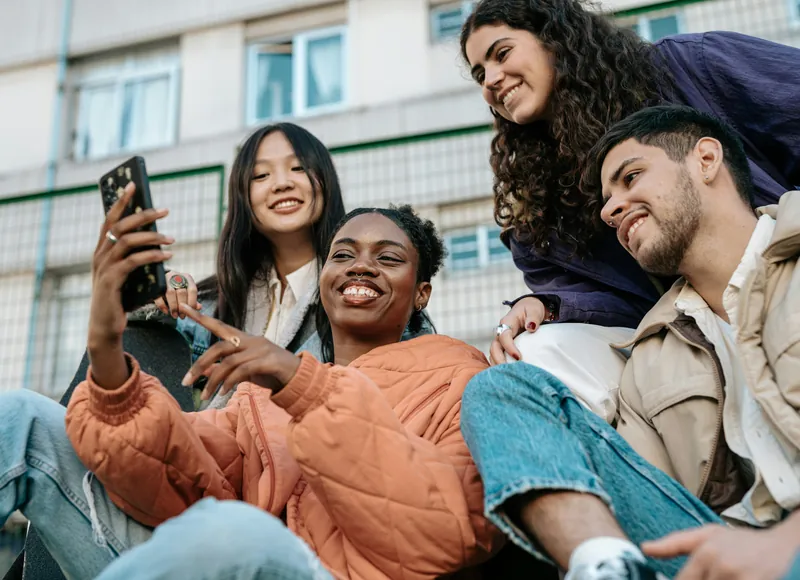 Friends looking at a phone together